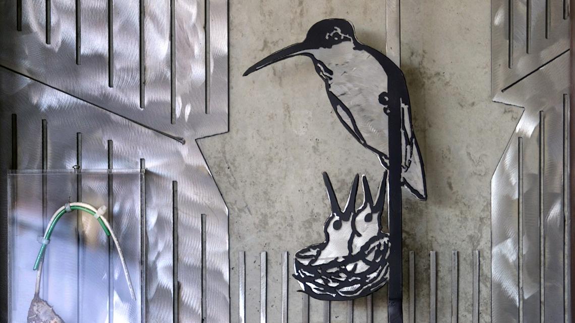 The first "residents" of the UA's ENR2 building — a mother hummingbird and her two babies — are now memorialized on the building's fifth floor. In the installment's lower left corner is part of the original nest and the data cable to which it was attached The first "residents" of the UA's ENR2 building — a mother hummingbird and her two babies — are now memorialized on the building's fifth floor. In the installment's lower left corner is part of the original nest and the data cable to which it was attached